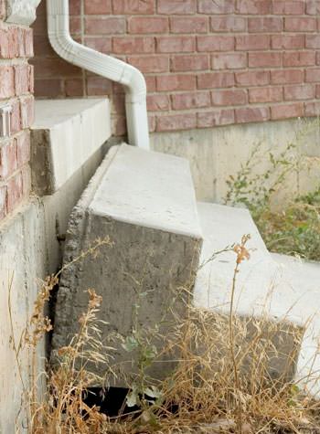 sinking outdoor concrete steps showing cracking and soil washout in Franklin
