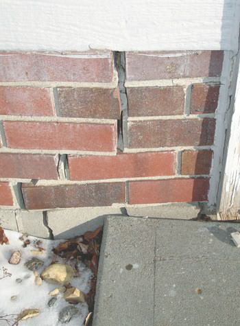 Severe street creep damage to a garage wall outside a Pickens home