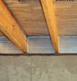 SilverGlo™ insulation installed in a floor joist in 