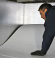 contractor installing TerraBlock™ floor insulation in a Easley crawl space
