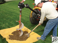 Auguring a hole in the earth for a foundation repair in Taylors