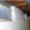 A foundation showing severe inward buckling along the windows in a Waynesville home.