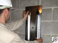 Mounting a foundation wall plate for an earth anchor installation in Simpsonville.