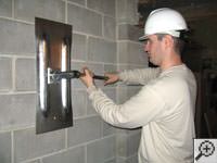 Attempting to straighten a bowed foundation wall by straightening a wall anchor system in a Easley home.