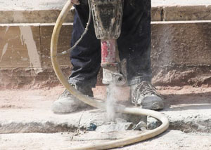 Jackhammering a slab floor in a Hendersonville home.