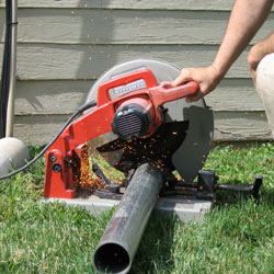 Cutting the support beam for a crawl space jack post outside a Easley home.