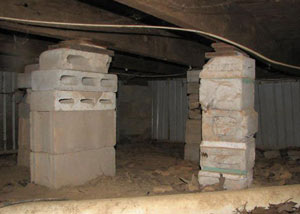 crawl space repairs done with concrete cinder blocks and wood shims in a Inman home