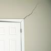 A long drywall crack beginning at the corner of a doorway in a Candler home.