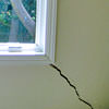 A long, diagonal crack that begins at a window corner of a Brevard home