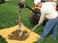 Auguring a hole in the earth for a foundation wall repair system in Easley