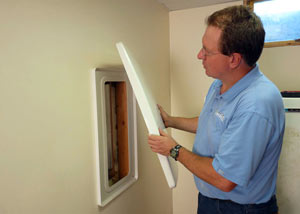 Foundation wall anchor covers installed in a finished basement with a repaired foundation wall in Pickens.