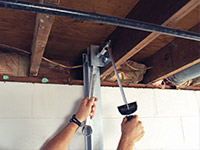 Straightening a foundation wall with the PowerBrace™ i-beam system in a Greenwood home.