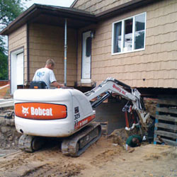 Excavating to expose the foundation walls and footings for a replacement job in Simpsonville