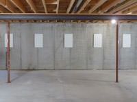 A repaired basement wall with foundation wall anchor covers installed in Hendersonville.