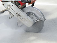 Cutting the driveway for expansion joints during street creep repair in Irmo