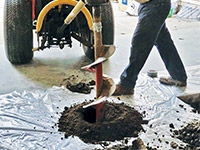 Digging the hole used for wall anchor installation in Laurens.