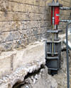 A completed installation of foundation push piers lifting a foundation in Irmo