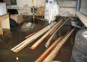 A severely flooding basement in Easley, with lumber and personal items floating in a foot of water