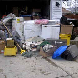Soaked, wet personal items sitting in a driveway, including a washer and dryer in Greer.
